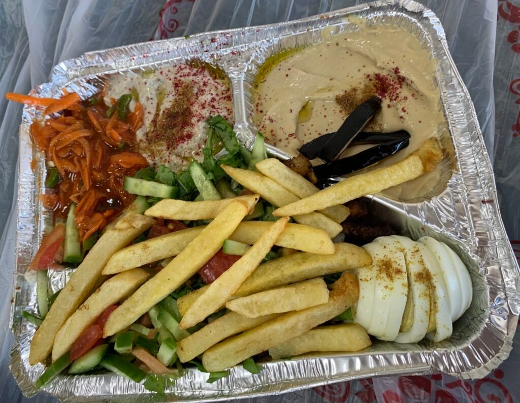 Hummus, Falafel, Egg, salad, flatbread and fries in Bisha.