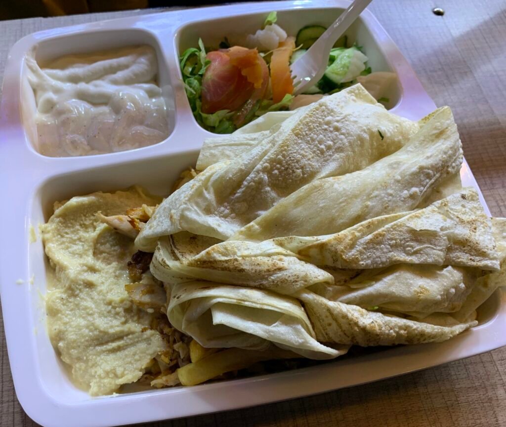 What I ate in oman. A plate shawarma for OMR1.4. There's chicken and fries below the bread.