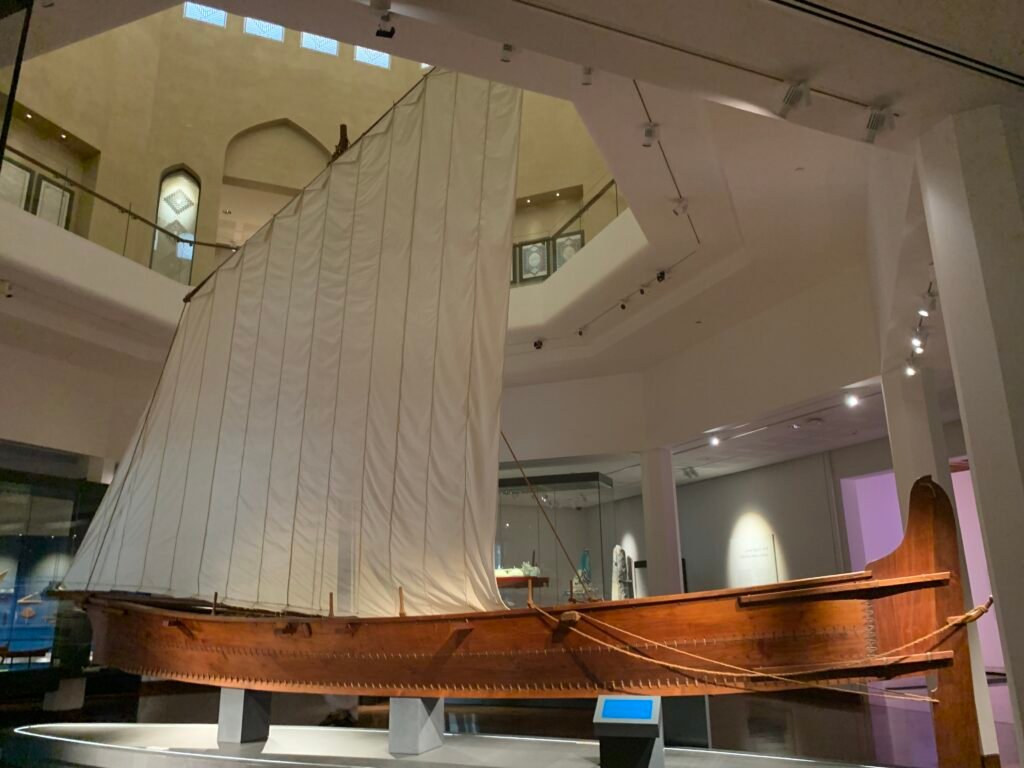 The larger hall showcasing a sea vessel in the Muscat National Museum.