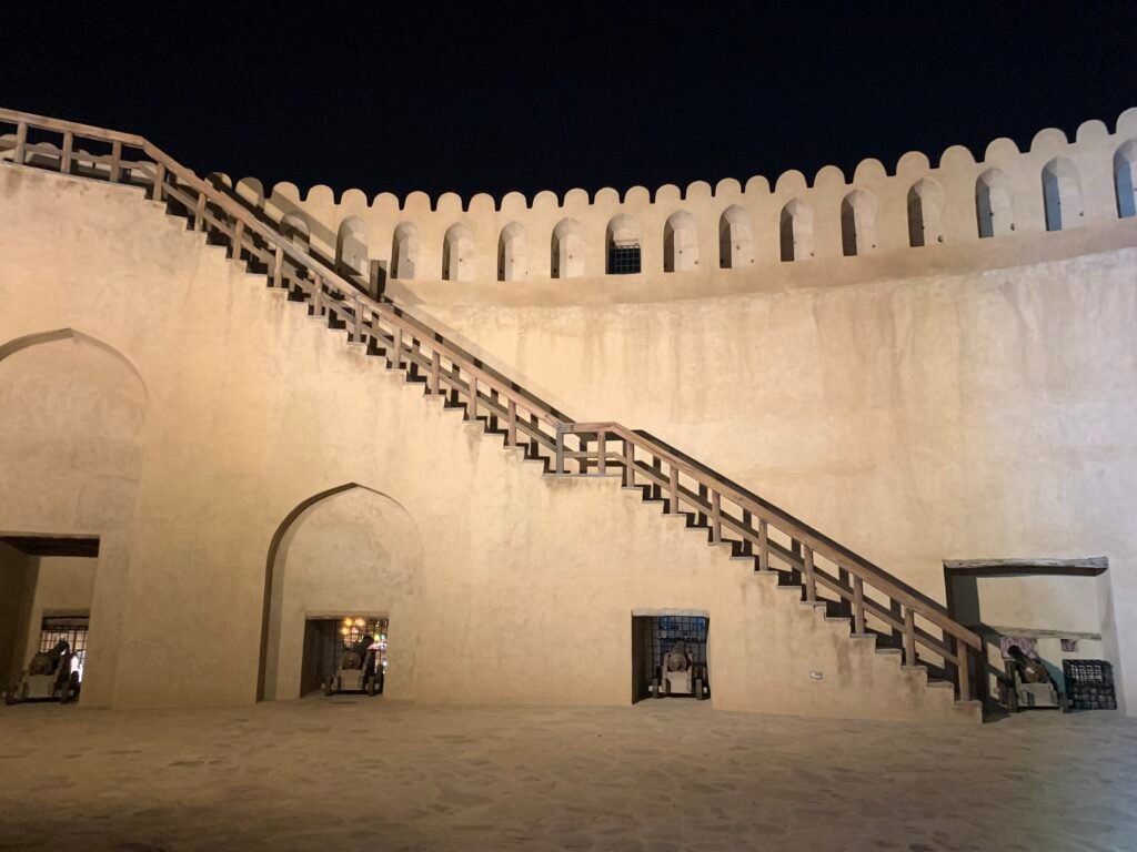 Budget Itinerary Oman. Inside Nizwa Fort starring at the protective walls where armies take defensive positions
