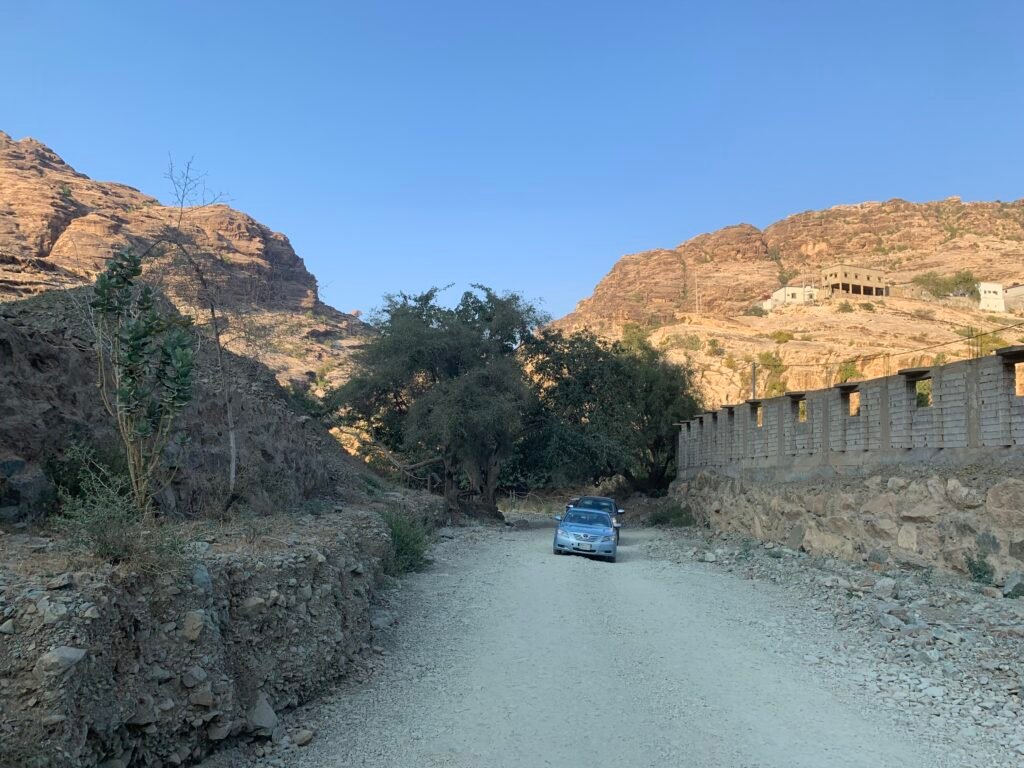 Sedans cars driving out from Wadi Lajab
