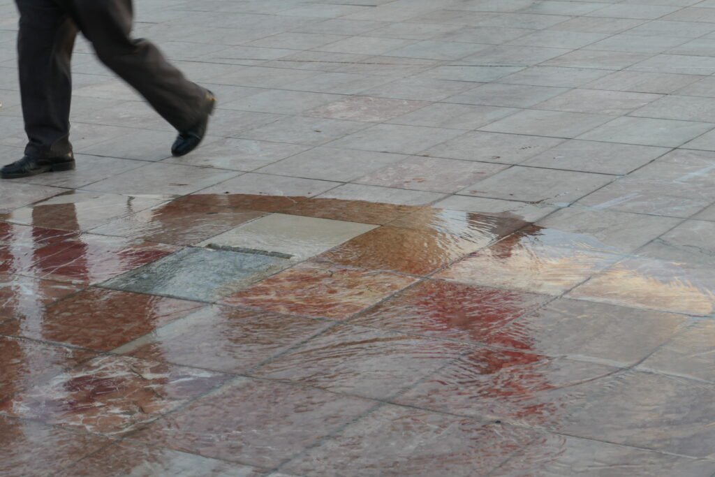 A outlet in the floor emitting water onto the square.